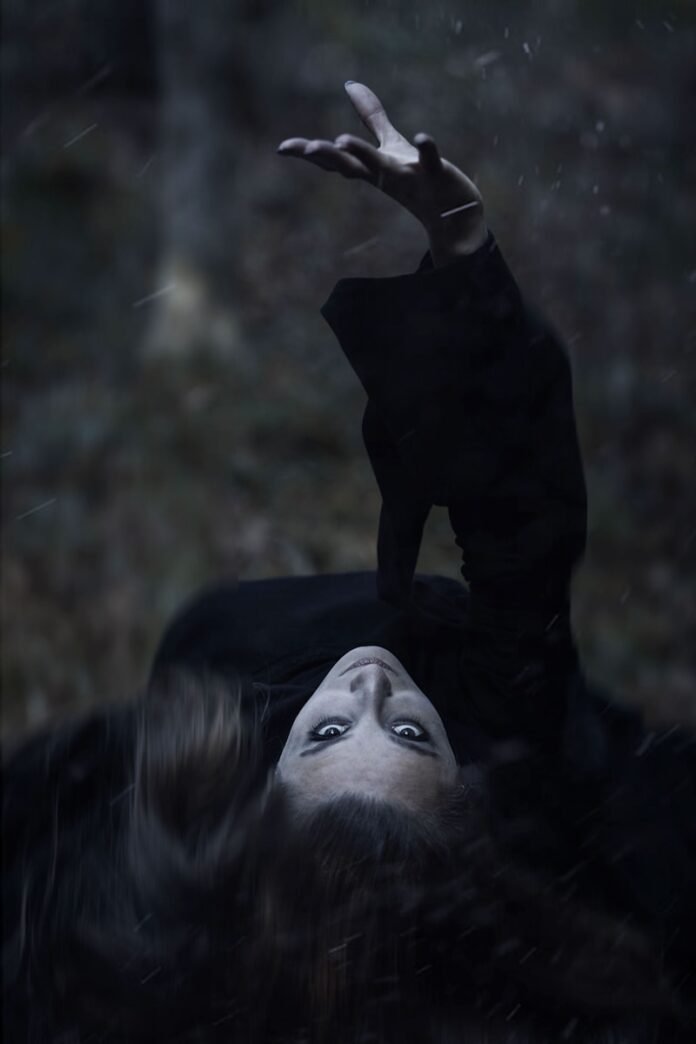 a woman laying on her back in the rain