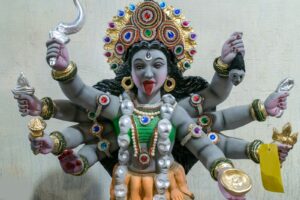 a statue of a hindu god with multiple arms and legs